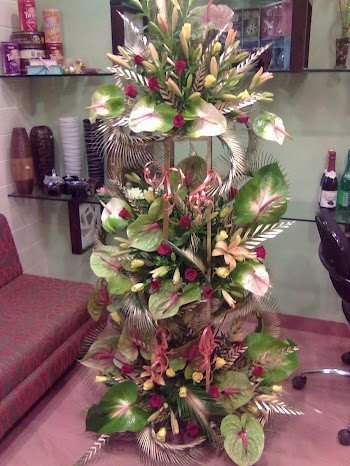  Exotic Premium Arrangement of 60 + Flowers 
Arrangement Includes: Anthurium, Oriental Lilies and Tube Rose with lush green decor with the help of stand.
 Height Aprox 3-4 Feet
&#8226 Free message card.
