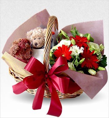 2 cute teddies arranged in flowers basket with 10 red and white flowers and crape paper packing.