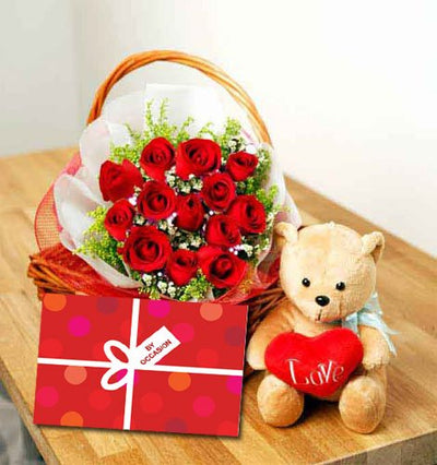  18 stem Red Roses arranged in a cane basket.
  Cute Teddy Bear (6 inch)
  Occasional Greeting Card