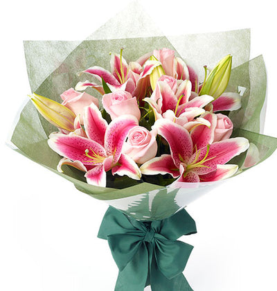  Pretty Pink Roses and Exotic Pink Lilies gorgeous bouquet 
 Beautifully arranged inspecial Pink wrap on it 
 14 + Flowers
 Free Message Card
