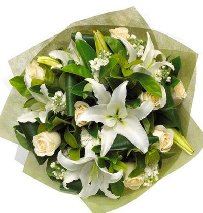  White Lilies and White Roses arranged in a gorgeous bouquet with cellophane paper wrap
 Free Message Card.