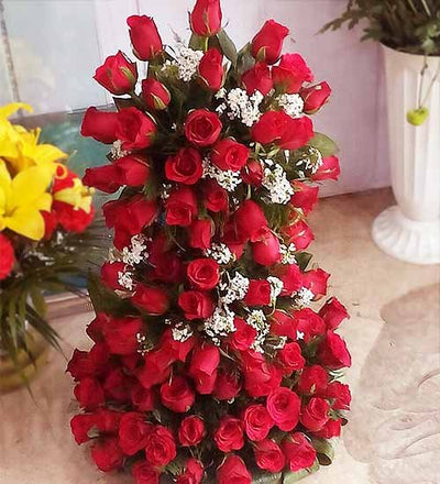  100 stalk of premium red roses arranged with the help of stand with lush green fillers in it.
 Height: Aprox 2.5-3 Feet
 Free Message card